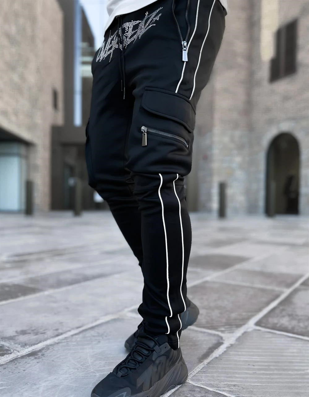 Stylish black athleisure cargo pants with zippered pockets and sporty side stripes