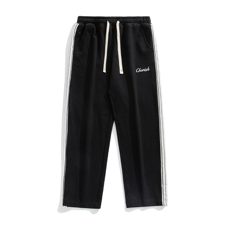 Stylish loose athleisure pants men in black with white stripes and adjustable drawstring
