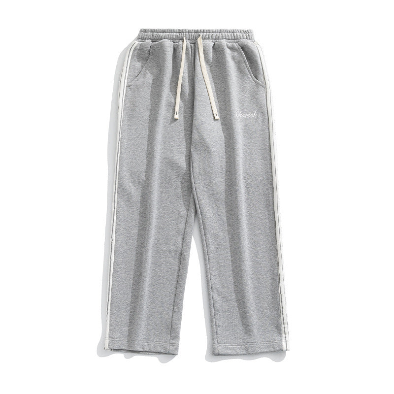 Grey loose athleisure pants men with a comfortable fit and side stripes for a stylish look