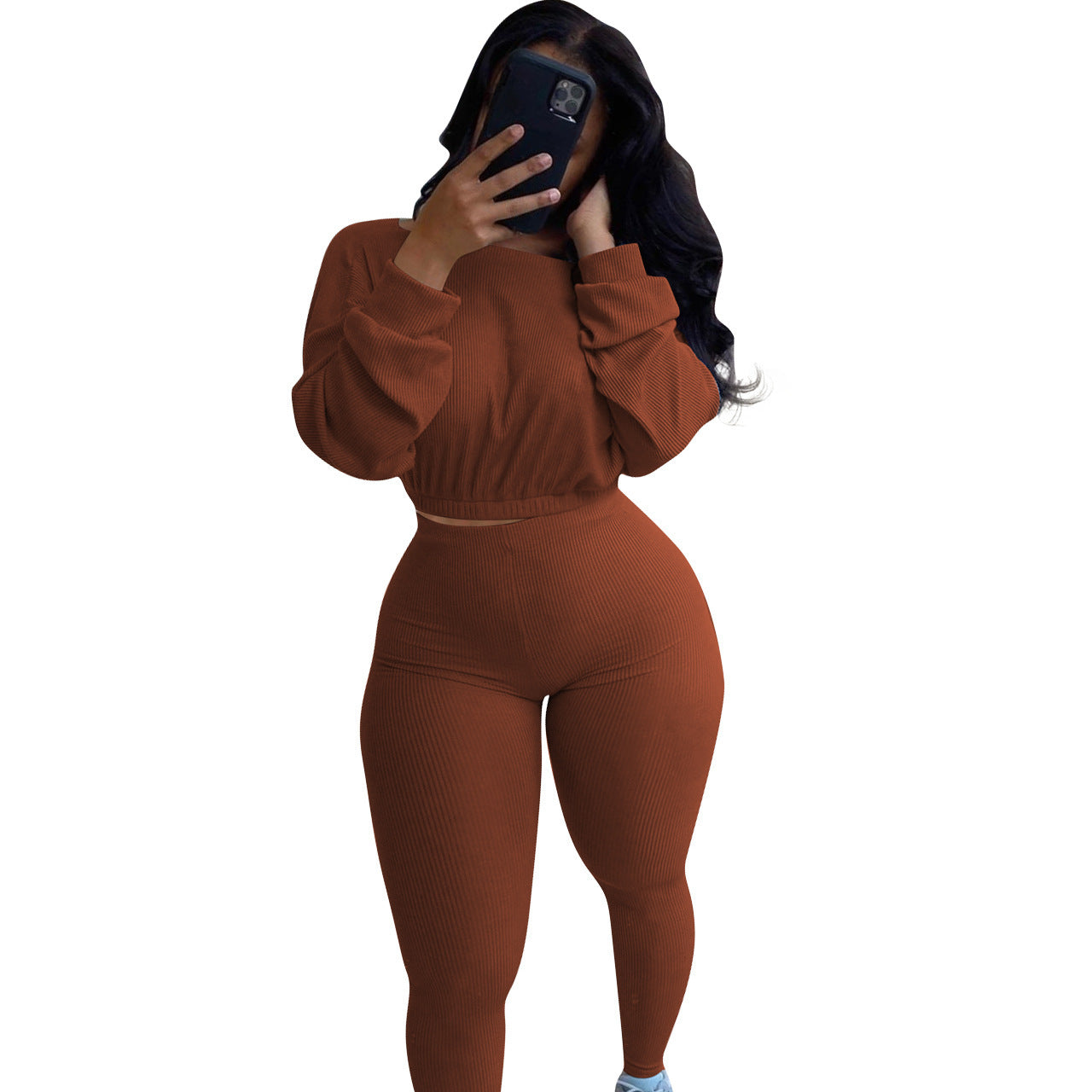 Women modeling an autumn ribbed athleisure suit in brown with long sleeves and fitted bottoms