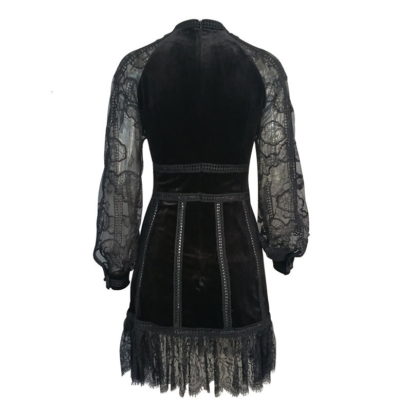 Back view of a black beaded sheer dress with elegant sheer sleeves and detailed embroidery