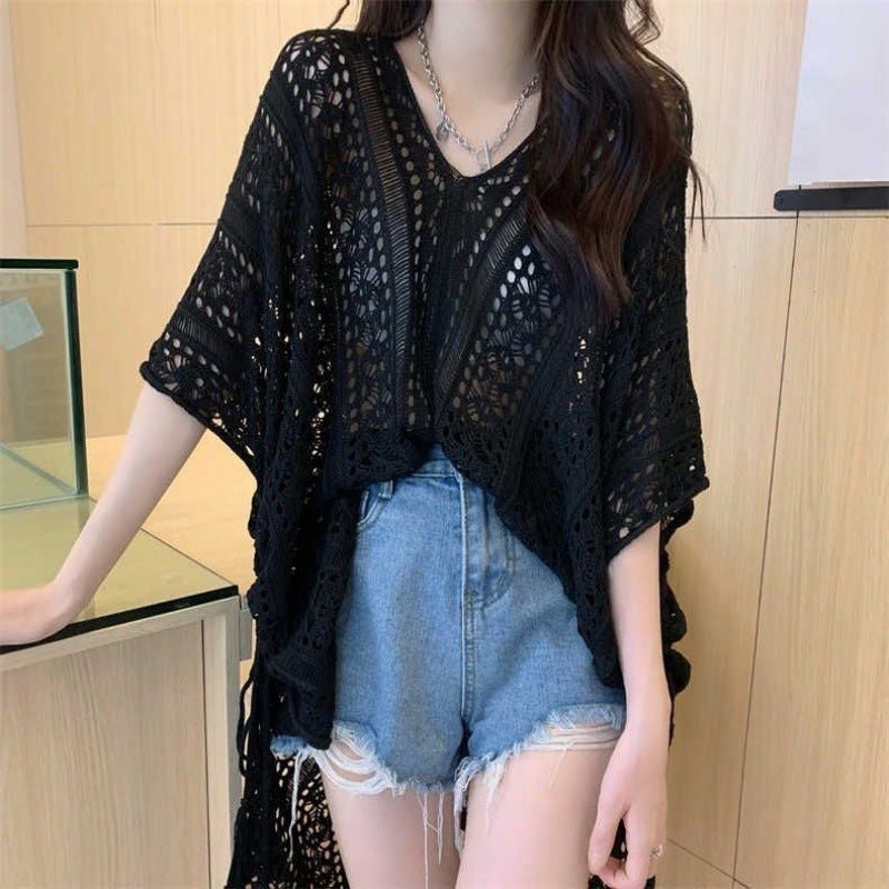 Chic loose smock top in black lace design paired with denim shorts for a stylish summer look
