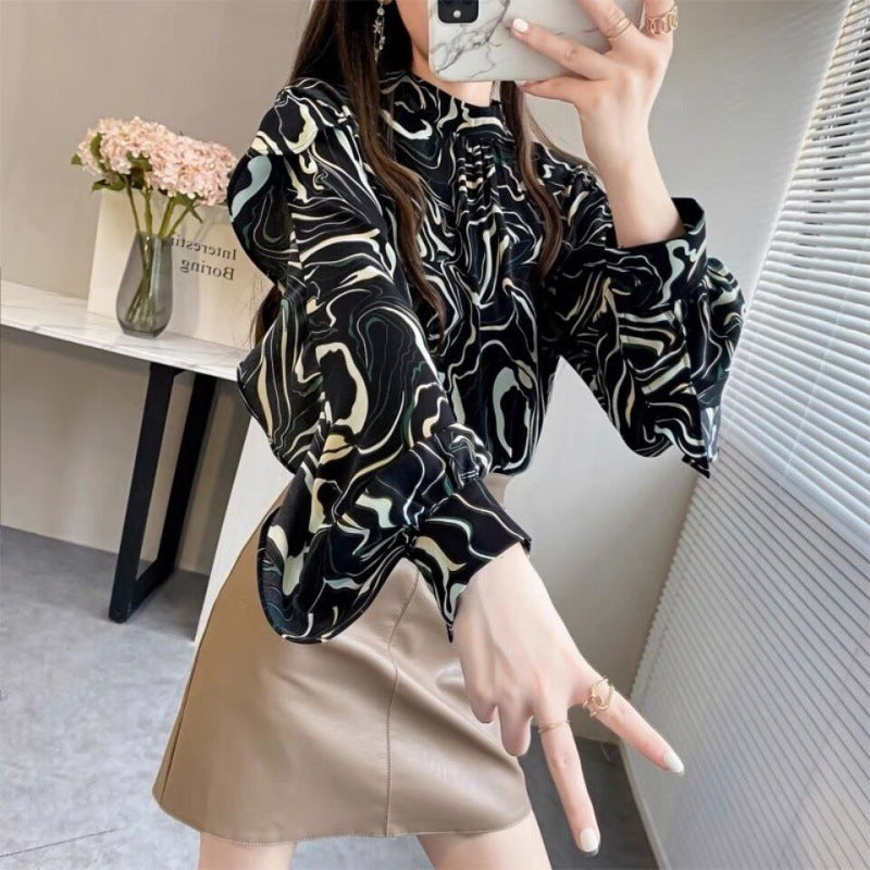 Chic ruffle top for women in abstract pattern paired with a stylish skirt