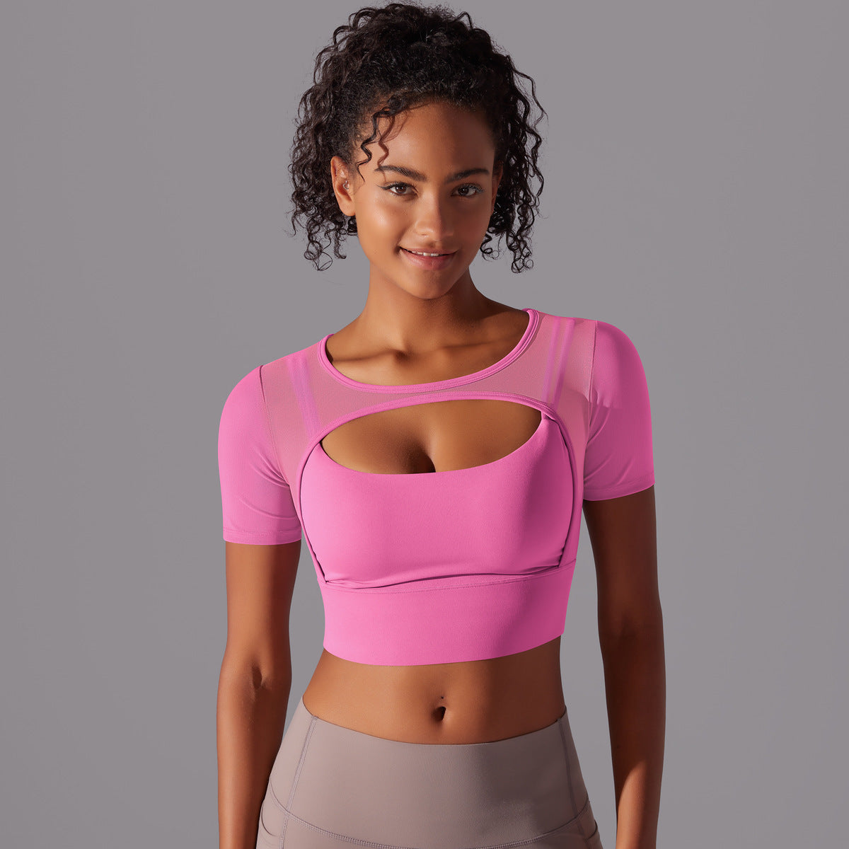 Stylish double layer yoga top for women in pink with a unique cut-out design and short sleeves