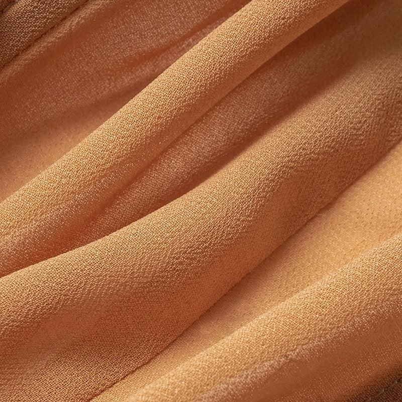 Soft fabric close-up of fashion mesh cropped tops for women in a light orange shade