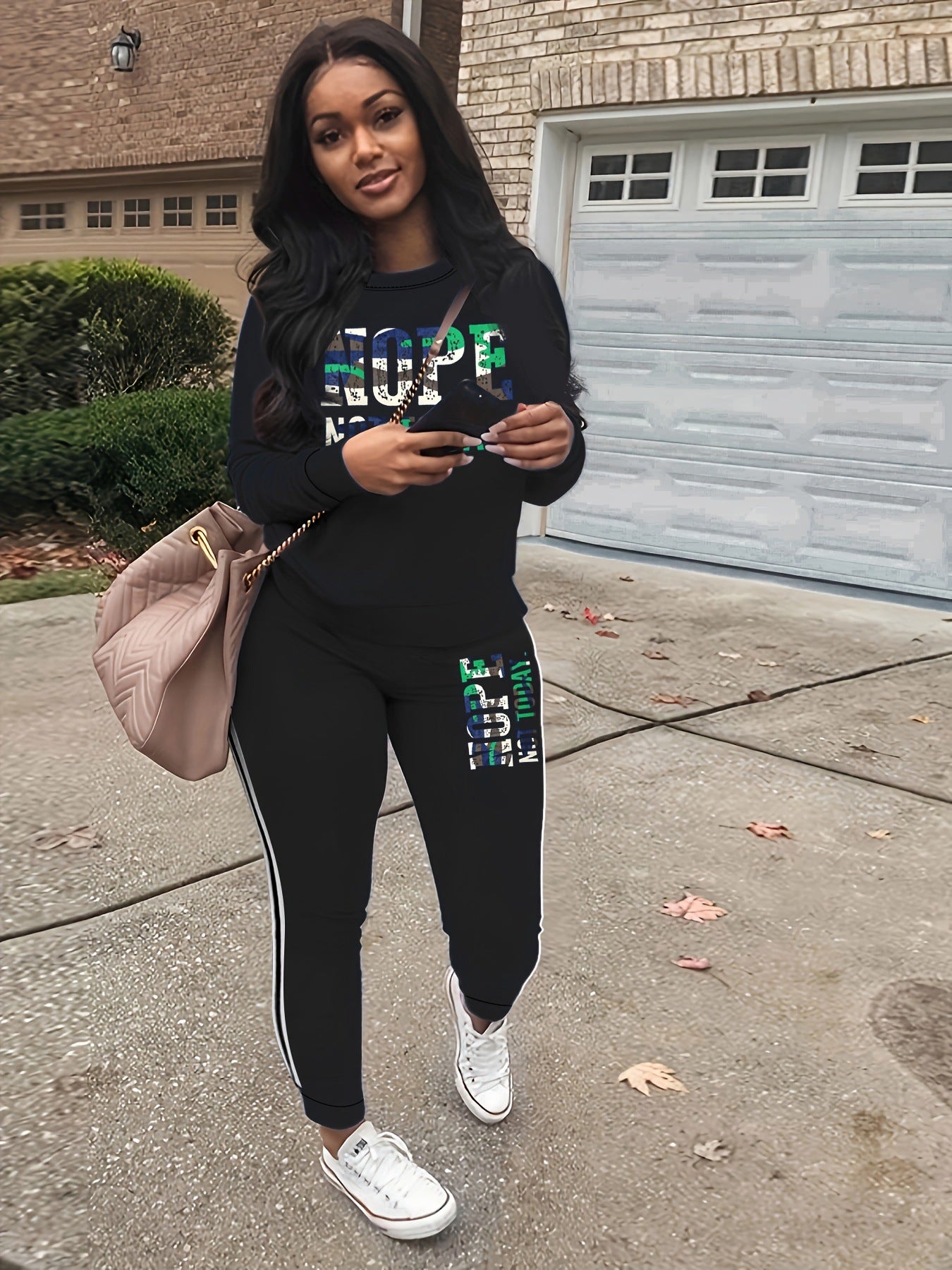 Stylish fleece-lined womens tracksuit with reflective lettering and side stripes, perfect for casual outings