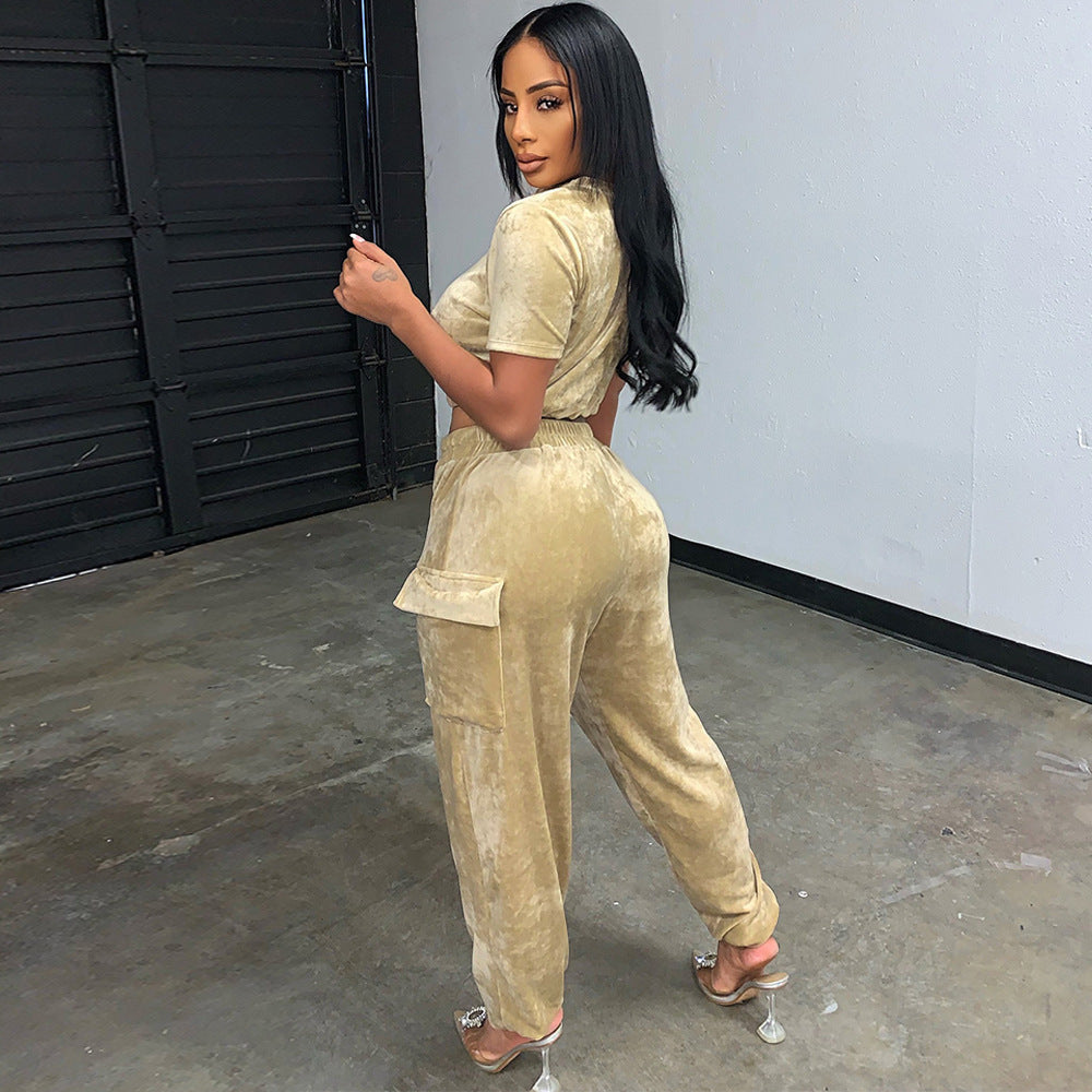 Stylish model showcasing a gold velvet athleisure set with a cropped top and relaxed pants