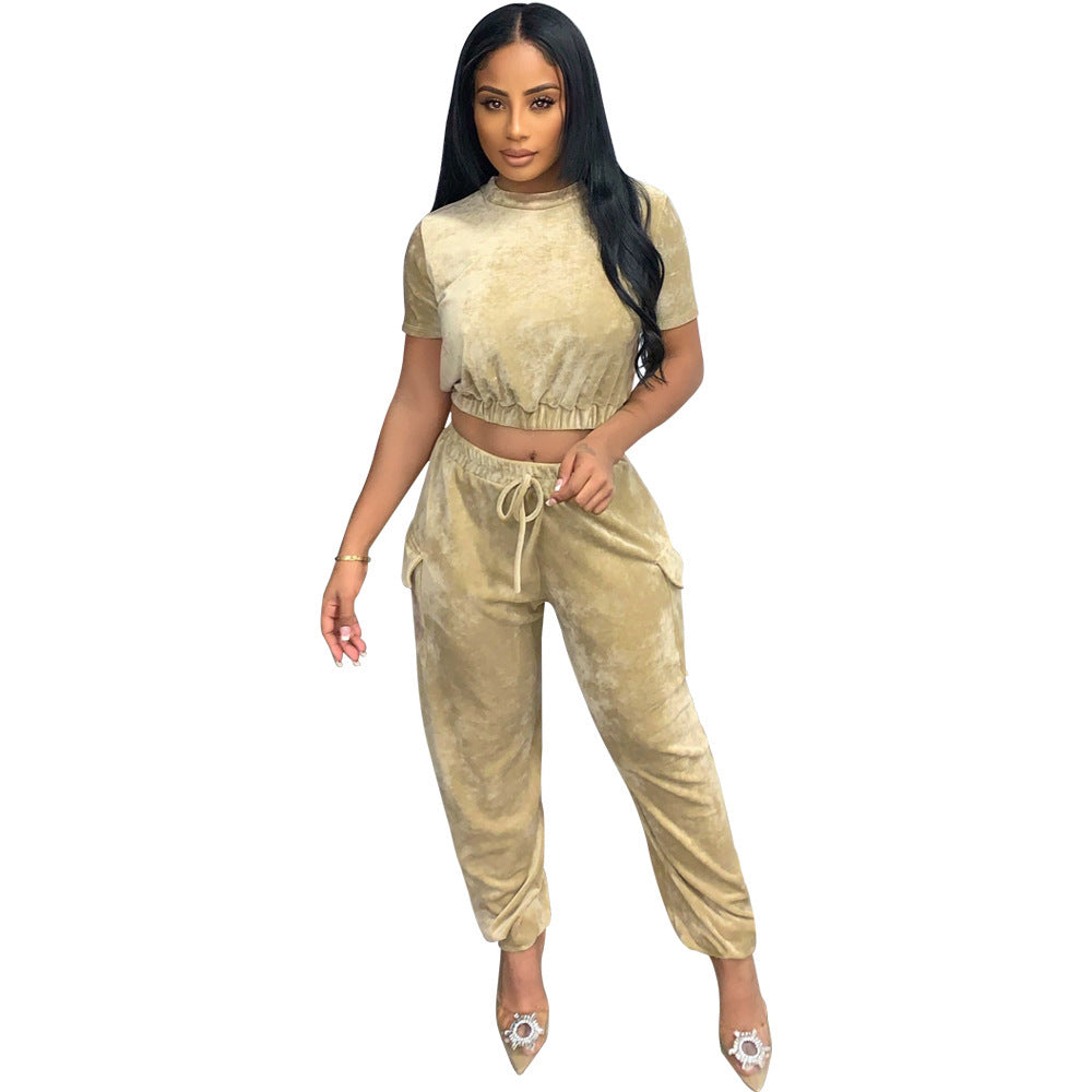 Stylish gold velvet athleisure set featuring a cropped top and jogger pants for a trendy look