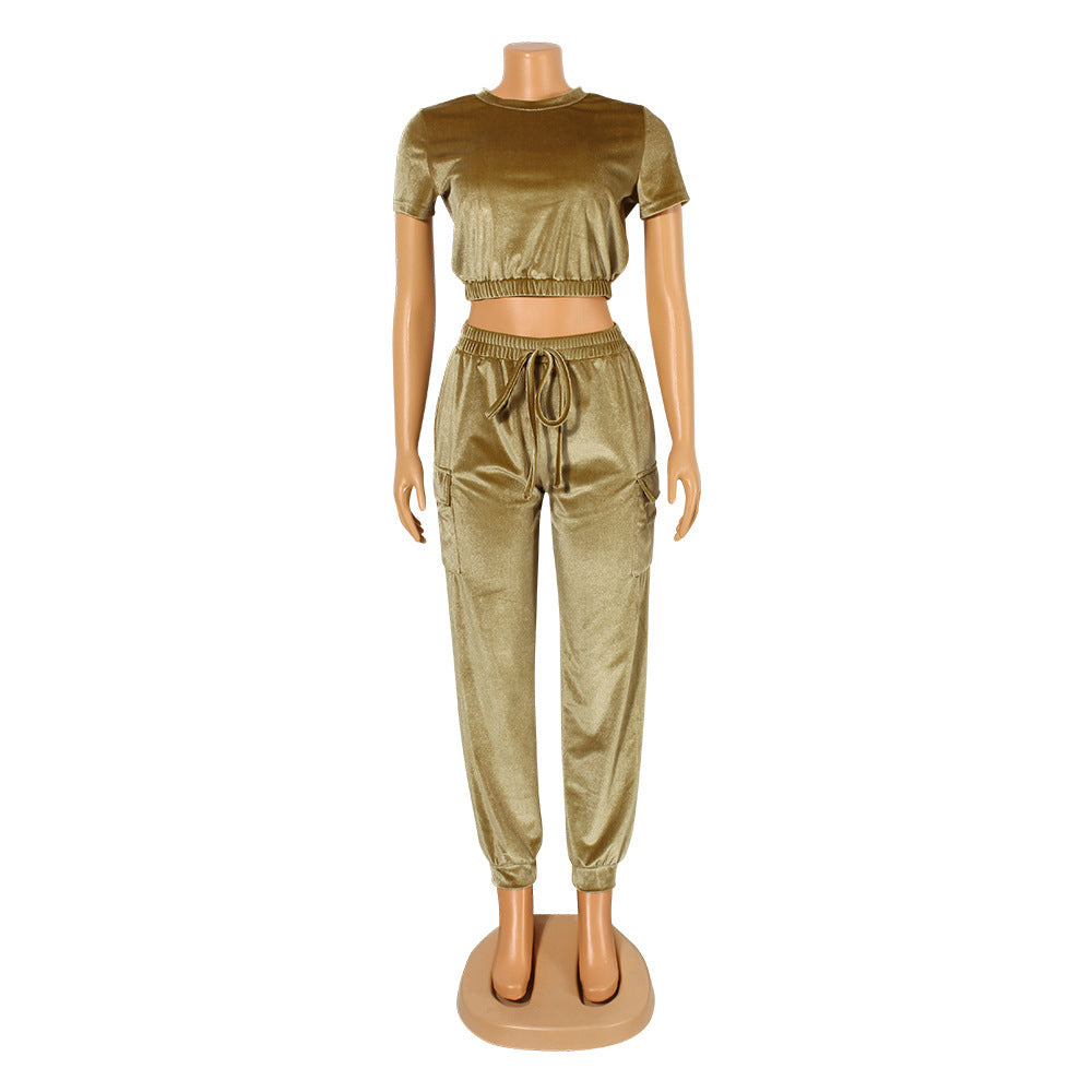 Stylish gold velvet athleisure set featuring a cropped top and tapered pants for trendy comfort