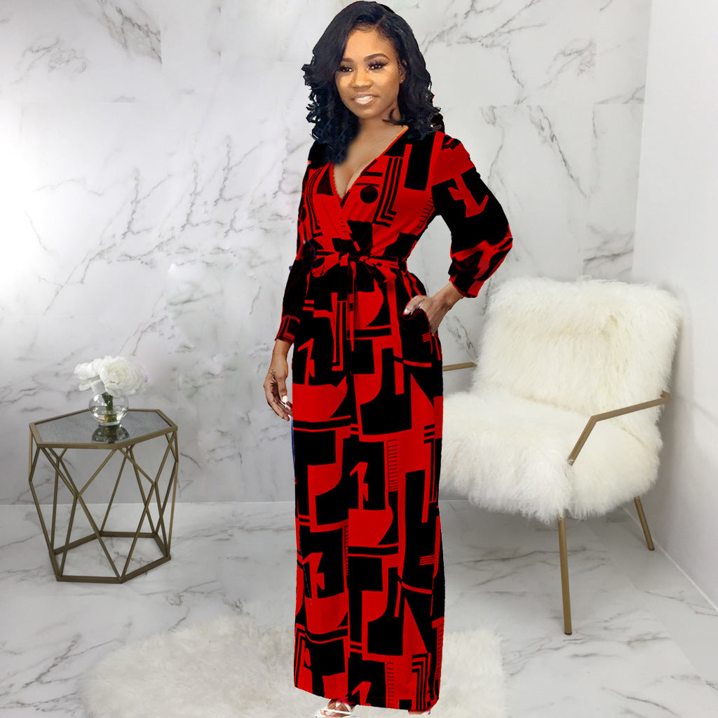 Stylish long sleeve ladies jumpsuit in red and black geometric pattern with a flattering waist tie