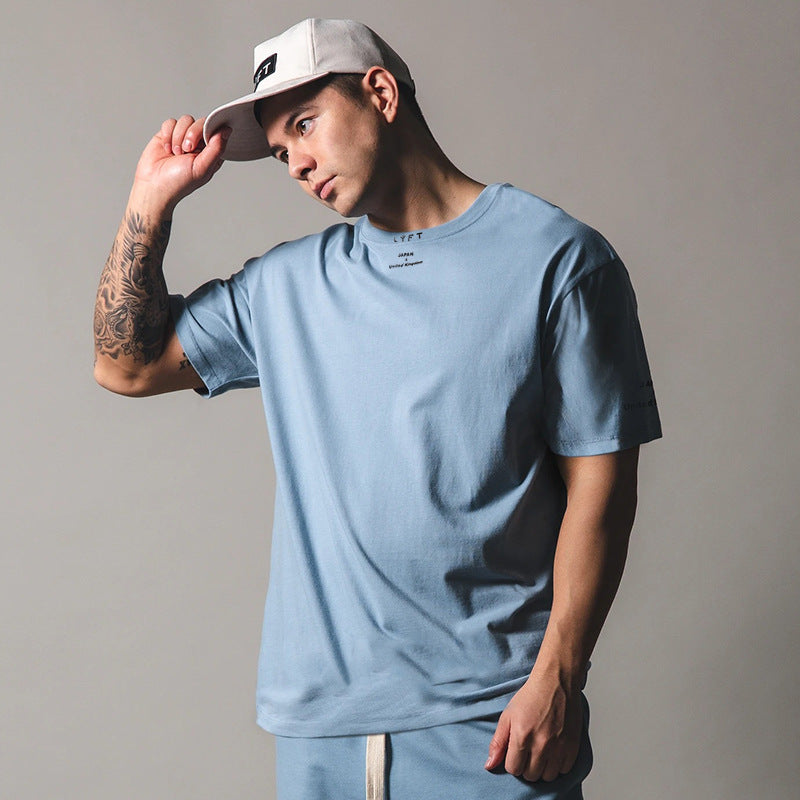 Light blue round neck athleisure shirt styled with a cap for a casual look