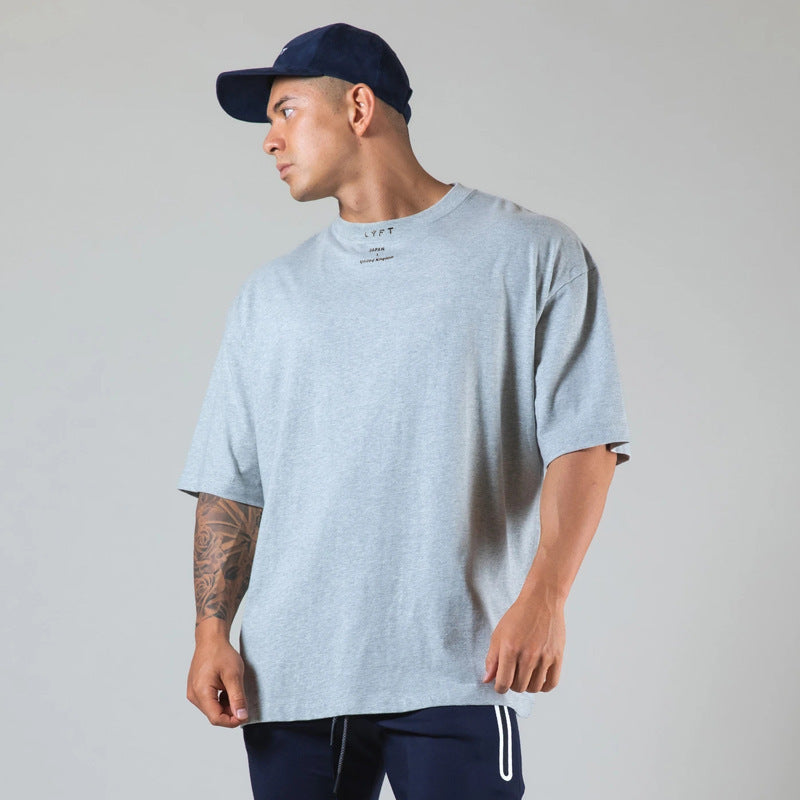 Men's gray round neck athleisure shirt with a relaxed fit, perfect for casual wear and workouts