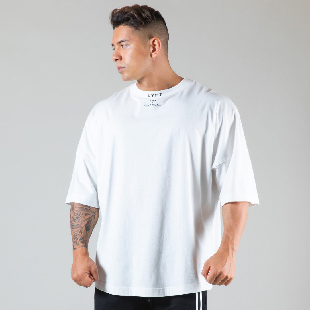 Men's round neck athleisure shirt in white, featuring a relaxed fit and short sleeves