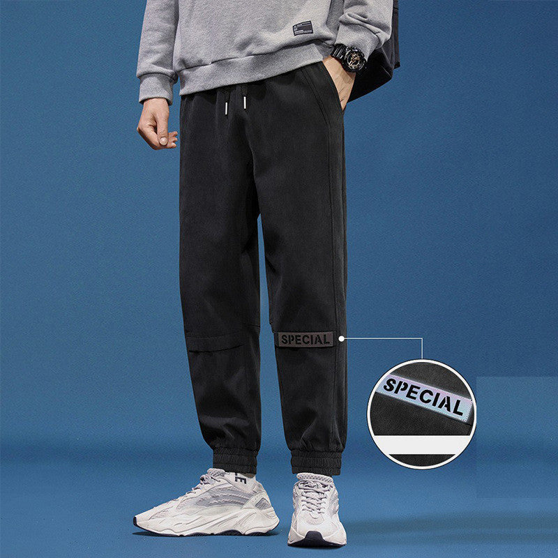 Men's reflective athleisure pants in black, featuring a comfortable fit and stylish design