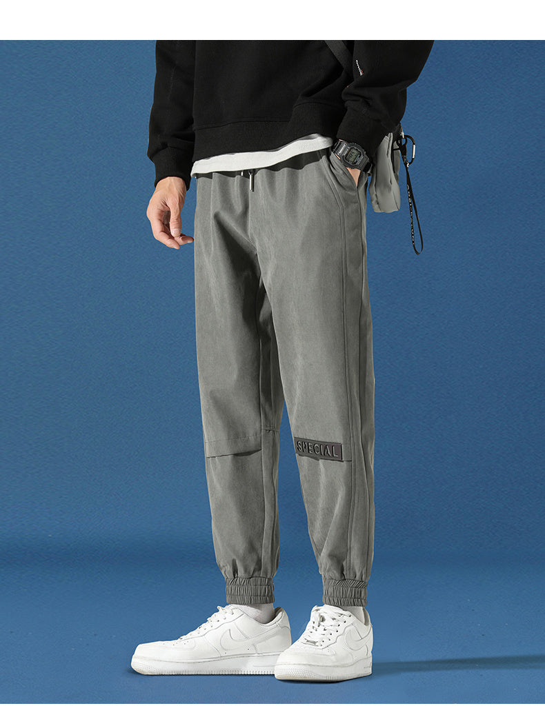 Men's reflective athleisure pants in gray with elastic cuffs and pockets for casual comfort