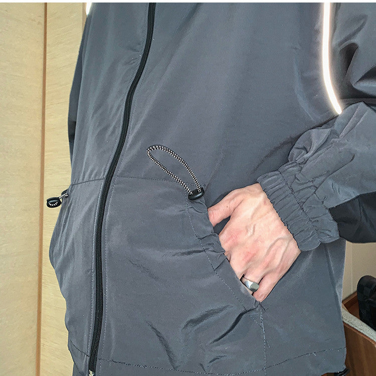 Men's reflective athleisure two piece set featuring a lightweight jacket and comfortable pants