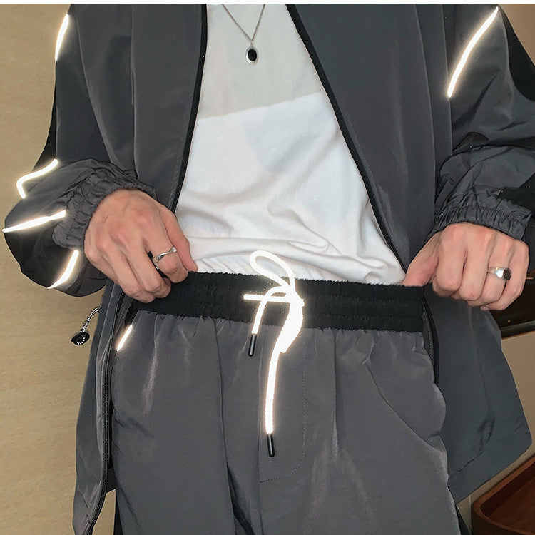 Men's reflective athleisure two piece set featuring a zip-up jacket and adjustable shorts