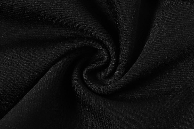 Close-up of smooth black fabric showcasing the material for mesh contrast bodysuit