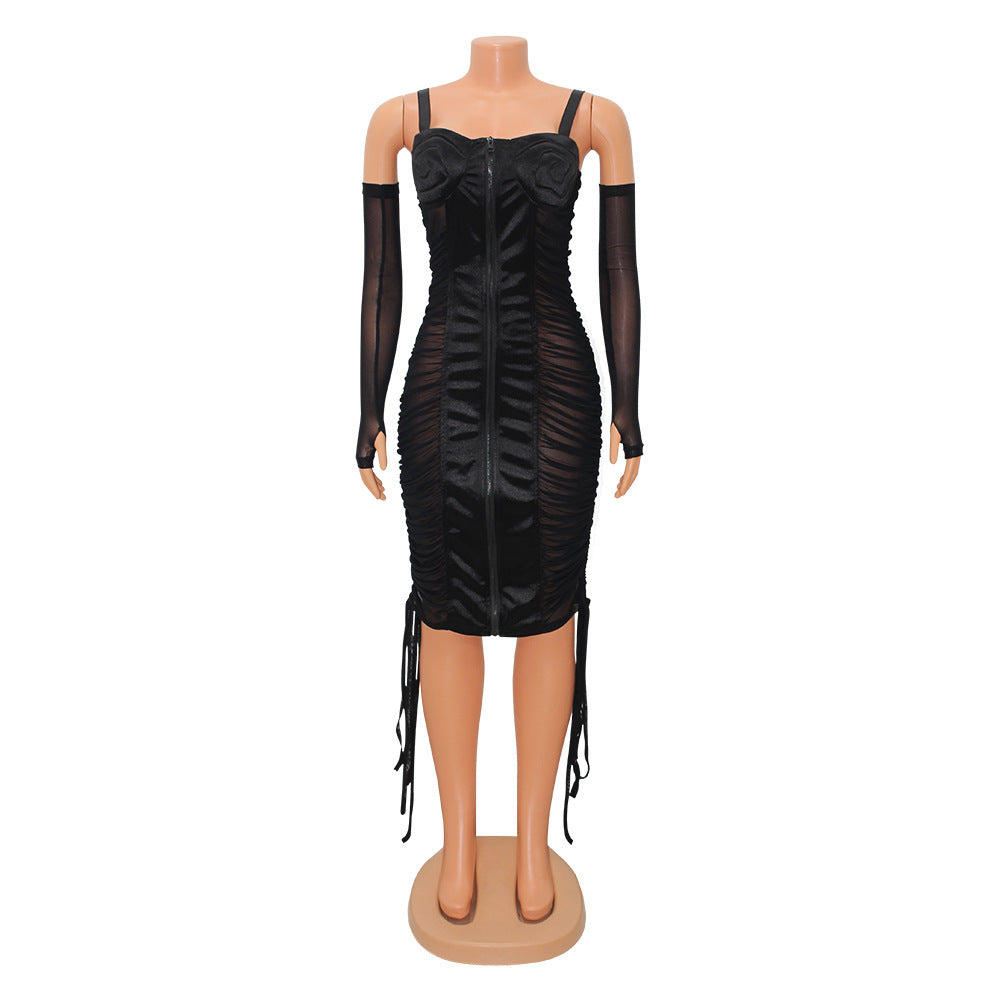 Stylish black mesh sling dress with ruched detailing and feather gloves for an elegant evening look