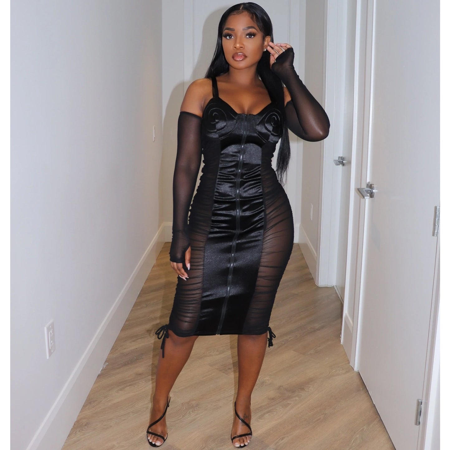 Stylish black mesh sling dress with sheer sleeves and fitted silhouette for a fashionable look