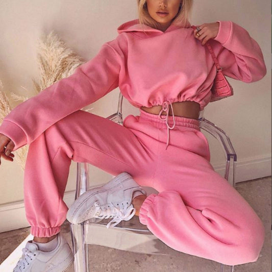Trendy pink 2 piece sports outfit for women with a cropped hoodie and jogger pants