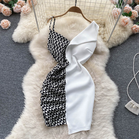 Stylish contrast panel slip dress featuring black and white houndstooth design with ruffle detailing