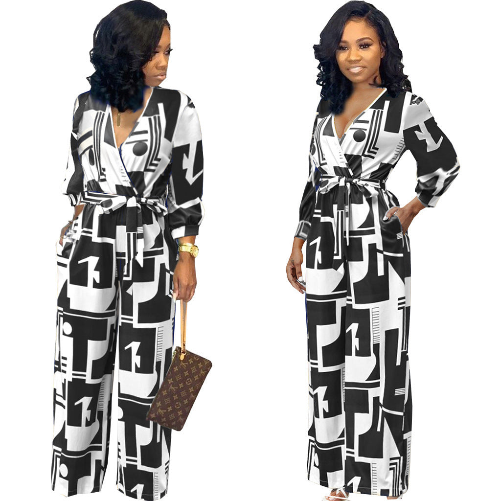 Stylish long sleeve ladies jumpsuit in black and white geometric print with tie waist detail