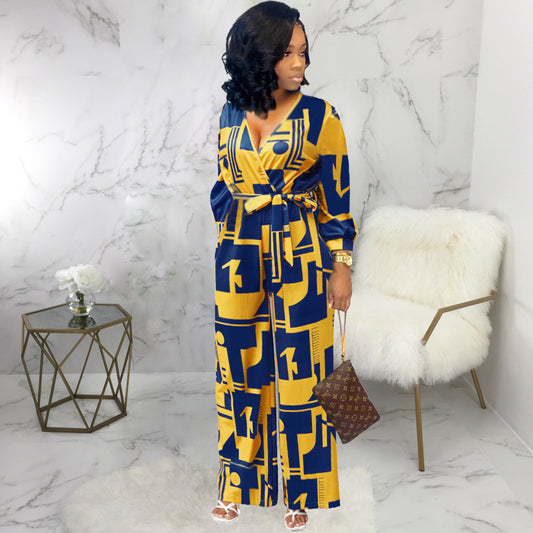Stylish long sleeve ladies jumpsuit in blue and yellow geometric pattern with a tie waist and wide legs