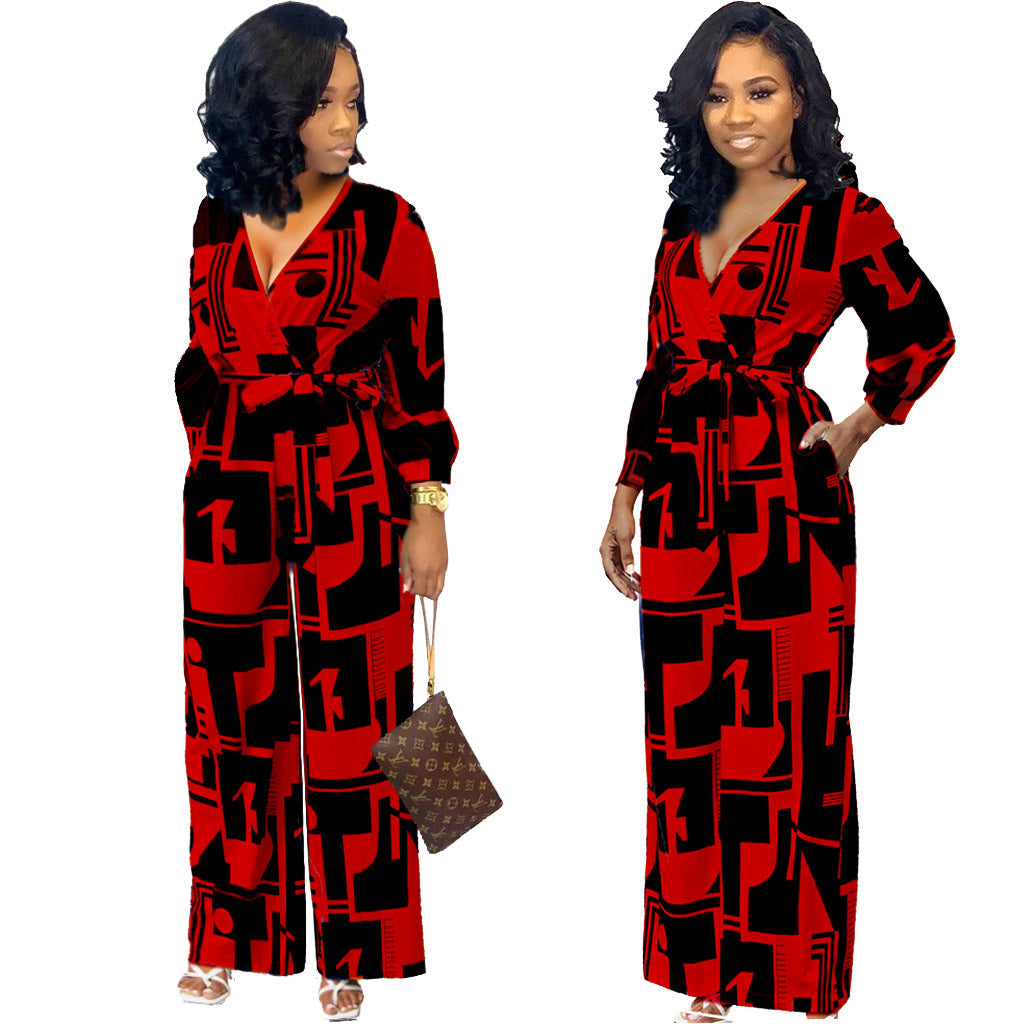 Stylish long sleeve ladies jumpsuit in bold red and black geometric design with a stylish belt